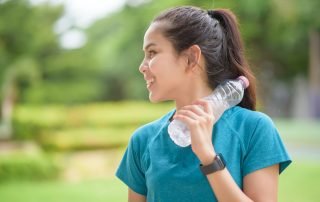 woman holding water bottle
